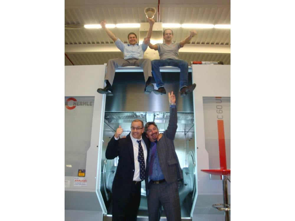 Three men are posing for a picture on the slide.